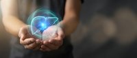 Hands holding glowing holographic brain with neural connections representing artificial intelligence, machine learning, and cognitive technology innovation.