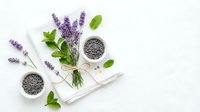 Fresh lavender flowers with chia seeds in bowls on white wooden background. Natural organic ingredients for healthy cooking and aromatherapy wellness.