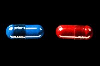 Red and blue medical capsules on black background, pharmaceutical concept with glowing pills isolated for healthcare and medicine designs.