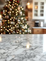 Marble kitchen counter with blurred Christmas tree and bokeh lights in background, creating festive holiday atmosphere in modern home interior.