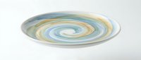 Swirling spiral pattern in soft blue, yellow, and cream tones creates a mesmerizing vortex effect on a flat circular surface, suitable for abstract backgrounds and modern design projects.