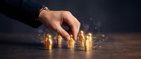 Male hand selecting glowing golden coins arranged on dark surface, representing financial decision-making, investment strategy, and wealth management for business concepts.