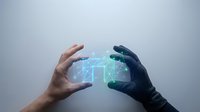 Human and robotic hands reaching toward glowing AI brain hologram representing artificial intelligence collaboration and future technology integration.