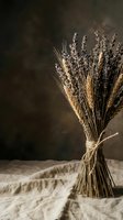 Dried lavender and wheat bundle tied with twine on linen fabric against rustic background for natural home decor and aromatherapy applications.