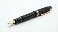Elegant black fountain pen with gold accents and nib isolated on white background for business writing and professional correspondence.