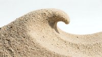 Sand wave formation on white background showcasing natural texture and flowing curves for creative design projects and educational materials.