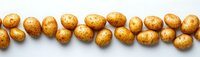 Fresh raw potatoes arranged in a row on white background, showcasing natural texture and earthy tones for culinary or agricultural content.