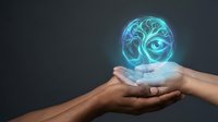 Glowing blue brain hologram floating above cupped hands against dark background representing artificial intelligence, mental health and neuroscience concepts.