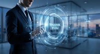 Professional businessman in suit touching holographic thank you interface with digital circles and futuristic technology elements in modern office.