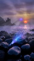 Surreal alien landscape with glowing fiber optic plant on rocky coastline under purple sky with twin suns reflecting on ocean waves at sunset.