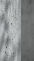 Close-up detail of weathered concrete column surface showing natural cracks and texture patterns in monochrome for architectural design projects.