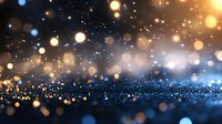 Magical glowing bokeh lights on dark blue background with golden sparkles and defocused particles creating dreamy atmospheric effect.