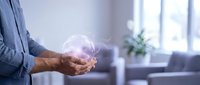 Businessman holding glowing digital sphere representing innovation, technology, and future business solutions in modern office environment.