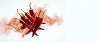 Fresh red chili peppers with vibrant spice powder explosion on white background, bold and fiery composition for food and culinary projects.