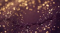 Golden bokeh lights scattered across deep purple background creating magical sparkle effect for festive celebrations and luxury design projects.