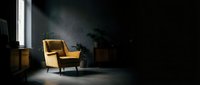 Mustard yellow mid-century modern armchair in minimalist dark interior with dramatic lighting, potted plant, and wooden furniture for contemporary home design projects.