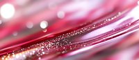 Pink and silver glitter scattered on diagonal metallic lines creates dreamy bokeh effect with soft focus and blurred background in macro photography.