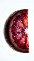 Red grapefruit half cut in cross section showing juicy pink and red segments with skin isolated on white background for food and nutrition design use.
