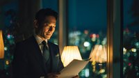 Confident businessman reading documents in luxury office at night with city lights background for corporate success concepts.