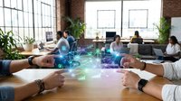 Business team collaboration with digital holographic data visualization and analytics charts floating above conference table in modern brick office space.