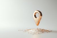 Metallic copper location pin marker floating above scattered sand particles on light background, minimalist composition for business and navigation concepts.