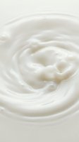 Creamy white swirl texture with smooth, flowing patterns ideal for cosmetics, skincare, dairy, and beauty product packaging backgrounds.