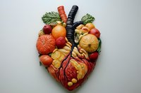 Creative food art depicting anatomical heart made from fresh fruits and vegetables on light background, symbolizing cardiovascular health and nutrition.