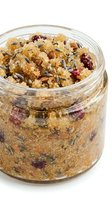 Homemade granola with dried berries, nuts, and lavender in glass jar, ready-to-eat breakfast cereal for healthy morning meals and snacking.