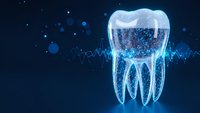 Digital tooth hologram with glowing blue light effects and particle elements on dark background for dental technology and healthcare concepts.