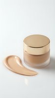 Luxury foundation cream jar with golden cap and makeup smear on white background for cosmetic branding and beauty product advertising.