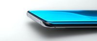 Modern smartphone with bright cyan blue screen displayed at angle on white surface, showcasing sleek device design for technology and mobile communication concepts.