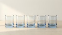 Five empty clear glass tumblers with blue tinted bottoms arranged in row on neutral background for kitchen and dining concepts.