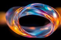 Abstract swirling light trails in blue, orange and purple colors create dynamic circular motion against dark background, glowing with ethereal luminescence.