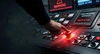 Industrial worker operating control panel with glowing red emergency button in manufacturing facility for safety and automation systems.
