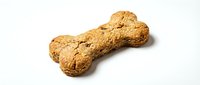 Crunchy dog bone-shaped treat with whole grain texture on white background, suitable for pet food packaging and veterinary marketing materials.