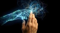 Human hand touching digital wireframe hand with glowing network connections representing artificial intelligence and human-technology interaction.