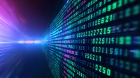 Digital matrix code stream with glowing numbers in blue, green and purple colors flowing into bright light perspective on dark background. Technology concept.