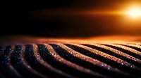 Macro shot of textured metallic surface with golden light reflection creating dramatic parallel lines and glowing sparkles against dark background.