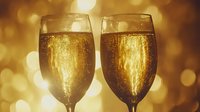 Two glasses of sparkling champagne with golden bubbles against warm bokeh background, perfect for celebration, toast, and festive event marketing materials.