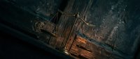 Sunken wooden sailing ship wreck resting on dark ocean floor with dramatic lighting revealing maritime archaeology and underwater exploration history.