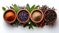 Aromatic spices and herbs in wooden bowls arranged in row with scattered peppercorns, bay leaves and dried lavender on white background, top view composition.