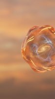Luminous glowing orb with swirling golden and purple energy patterns floating against warm peachy gradient background. Isolated sphere for design use.