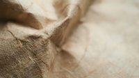 Natural burlap sack texture with rough hemp fabric fibers and organic jute material surface for rustic packaging and eco-friendly design projects.