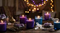 Colorful candles with crystals and gemstones create mystical atmosphere for meditation, spiritual healing, wellness rituals and aromatherapy relaxation.