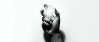 Hand holding light bulb against white background symbolizing innovation creativity and bright ideas for business presentations and educational content.