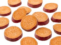 Sweet potato slices scattered on white background, isolated, showing vibrant orange flesh and purple skin, fresh cut vegetable rounds for food design.