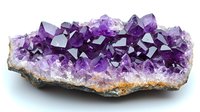 Natural amethyst crystal cluster formation with deep purple crystalline structures emerging from raw stone base, displaying geometric shapes and varying translucent tones.