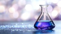 Glass laboratory flask with blue purple liquid on sparkling surface with soft bokeh lights background for scientific research and chemistry experiments.