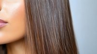 Close-up of woman with long straight brown hair showing healthy shine and texture for haircare and beauty treatments.