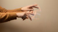 Expressive hands in motion creating dynamic gestures against neutral background for creative projects and artistic expression concepts.